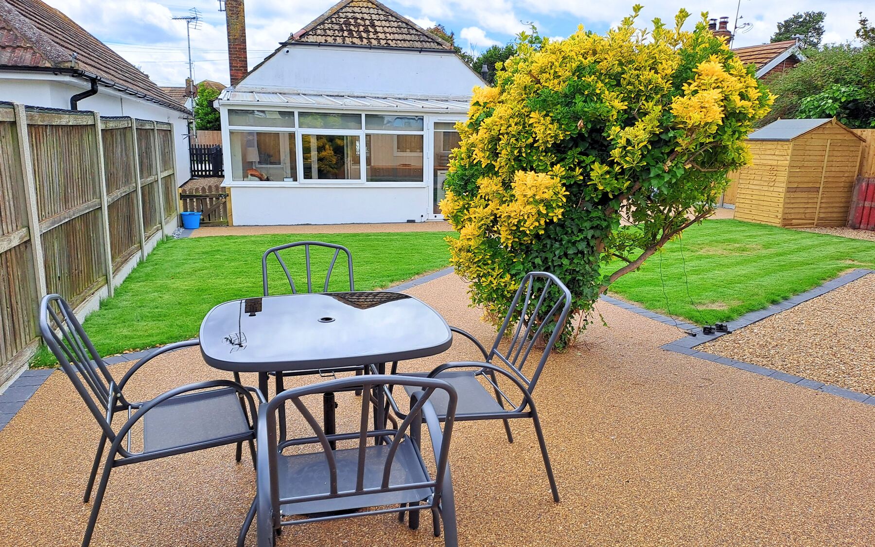 Sunny conservatory with level access to the resin patio and garden